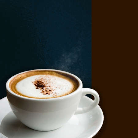 Close up a cup of hot Cappuccino on background with copy space in square size imageの写真素材