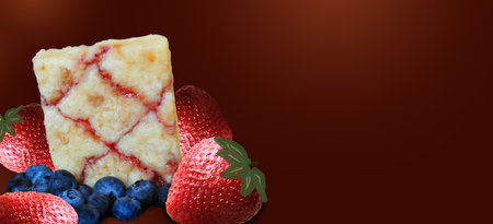 Berry fruits brownie cake on red background with copy space in banner sizeの写真素材