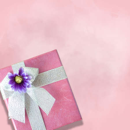 Close up pink gift box on pink background in square size imageの写真素材