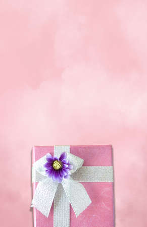 pink paper gift box on pink background with copy spaceの写真素材