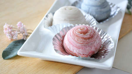 Close up sweet pink pastry filled with bean serving on white plateの写真素材