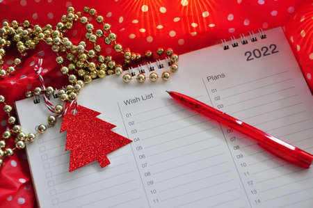 Red pen point to wish list headline on polka dots red background in Christmas conceptの写真素材