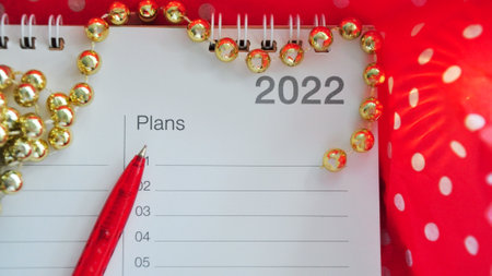 Close up pen point to blank plans list on year 2022 on red background in banner size imageの写真素材