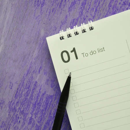 Pen point to first of month to do list with blank space on violet background in square size imageの写真素材
