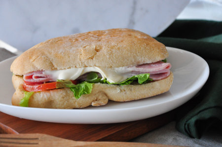 Close up ham cheese sandwich on white dishの写真素材