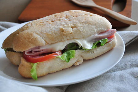 Close up cheese ham sandwich on white plateの写真素材