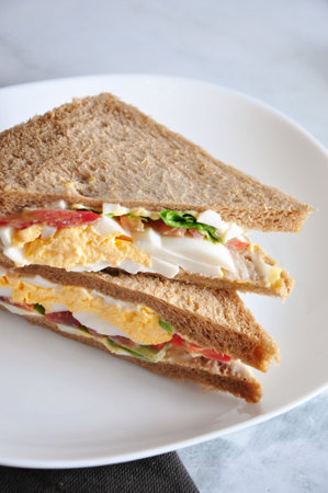 Close up healthy meal egg sandwich serve on white plateの写真素材