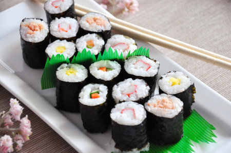 Close up Japanese food Sushi set roll set on white plate with chopstickの写真素材