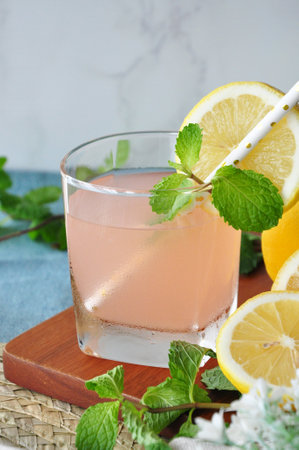 Fresh grapefruit juice with mint and lemon sliced on topの写真素材