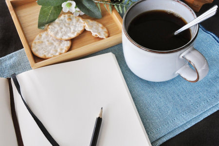 Top view of copyspace on blank page and black coffee on tableの写真素材