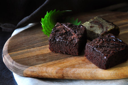 Homemade fudge brownies put on wooden board with copyspace on dark backgroundの写真素材