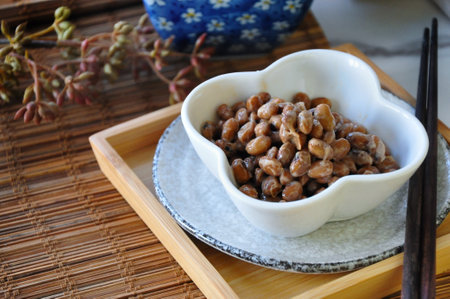 Natto helathy Japanese food in white bowl with chopstick serve on wooden trayの写真素材