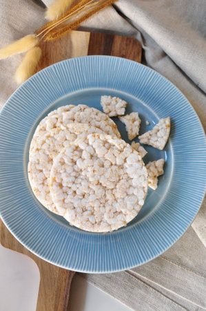 Top view of healthy snack Jasmin rice cracker on blue plateの写真素材
