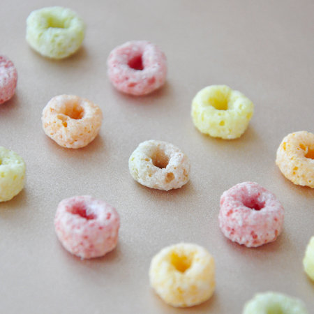 Close up row of colorful fruit loops cereal on backgroundの写真素材