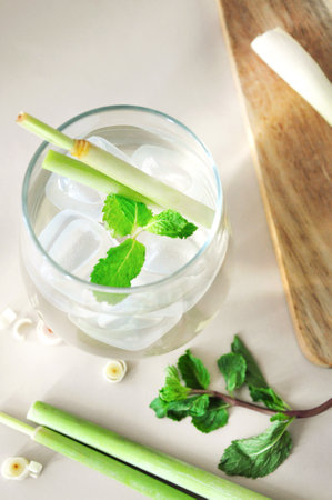 Top view a glass of fresh lemongrass drink on background with fresh lemongrass and mintの写真素材