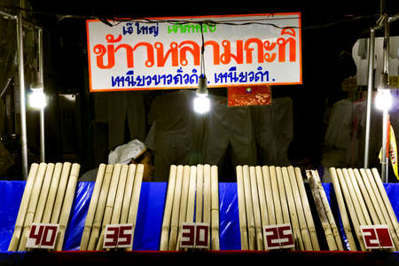 PHUKET, THAILAND SEPTEMBER 26, 2011: A vendor sells bamboo shoots stuffed with coconut sticky rice during pre-festival activities for the annual Phuket Vegetarian Festival in Phuket Town.のeditorial素材
