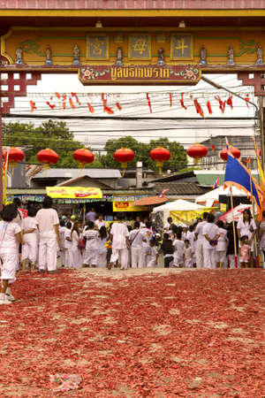 PHUKET, THAILAND OCTOBER 2 2011: The main gate of the Bang Niew Chinese Shrine in Phuket Town is littered with exploded firecrackers at the conclusion of a ceremony during the annual Phuket Vegetarian Festival.のeditorial素材