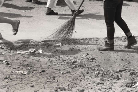 PHUKET, THAILAND OCTOBER 2 2011: A groundskeeper at the Bang Niew Chinese Shrine in Phuket Town sweeps up exploded firecrackers during the annual Phuket Vegetarian Festival. のeditorial素材