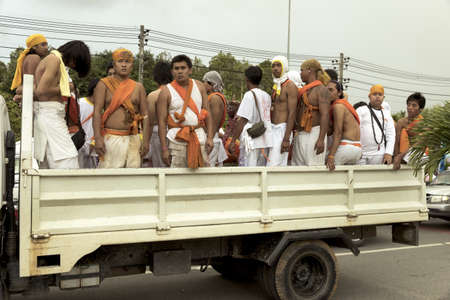 PHUKET, THAILAND OCTOBER 2 2011: A truck load of attendants for a Ma Song wait for the start of a street procession in the rear of a flatbed truck during the annual Phuket Vegetarian Festival in Phuket Town. のeditorial素材