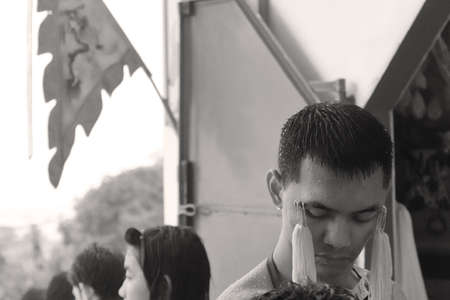 PHUKET, THAILAND OCTOBER 5 2011: A Mah Song (spirit medium) waits to have ceremonial needles removed at the Sui Boon Tang Chinese Shrine in Phuket Town during the annual Phuket Vegetarian Festival.のeditorial素材
