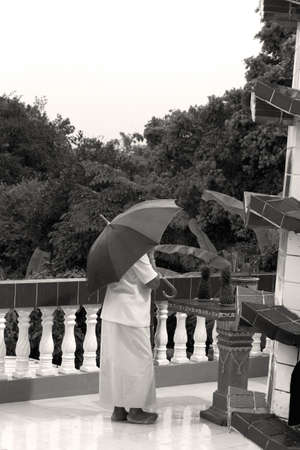 PHUKET, THAILAND OCTOBER 5 2011: An elderly woman lights incense at the Sui Boon Tang Chinese Shrine in Phuket Town during the annual Phuket Vegetarian Festival.のeditorial素材