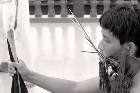PHUKET, THAILAND OCTOBER 5 2011: A Mah Song (spirit medium) with face pierced waits for the start of a street procession at the Sui Boon Tang Chinese Shrine in Phuket Town during the annual Phuket Vegetarian Festival.のeditorial素材