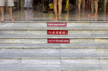 PHUKET, THAILAND: SEPTEMBER 6 2011: Vistors at the Jui Tui Shrine in Phuket, Thailand remove their shoes before entering the Jui Tui Chinese Shrine in Phuket Town..のeditorial素材