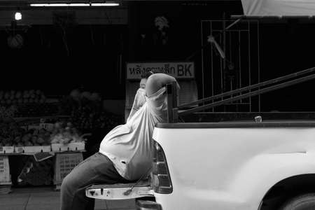 PHUKET, THAILAND MAY 29 2012: A worker takes a time out whilst  making a delivery to a produce store on Patong Beach in Phuket. のeditorial素材