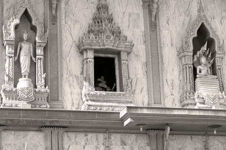 PHUKET, THAILAND APRIL 28 2013: A mother and children look out the window of a stupa at Wat Chalong, the largest Buddhist Temple in Phuket. のeditorial素材