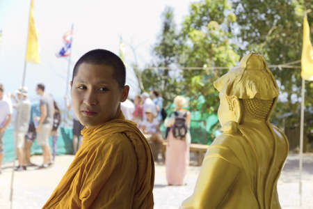 PHUKET, THAILAND FEBRUARY 15 2013: A Buddhist monk visits the Big Buddha Monument, an iconic symbol of Thai Buddhism and one of the most visited religious landmarks in Phuket.のeditorial素材