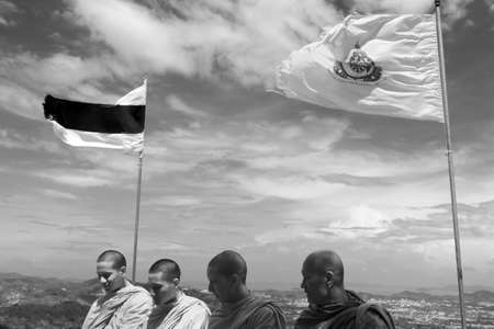 PHUKET, THAILAND FEBRUARY 15 2013: A quartet of Buddhist monks visit the Big Buddha Monument, an iconic symbol of Thai Buddhism and one of the most visited religious landmarks in Phuket.のeditorial素材