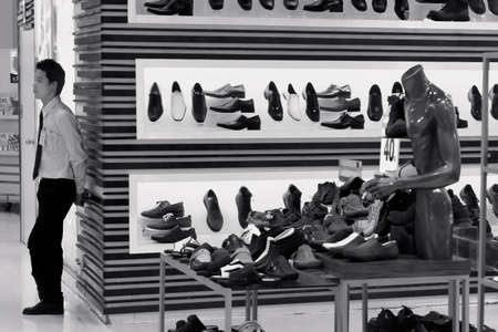 PHUKET, THAILAND MAY 22 2012: A security guard stands watch over shoes in a department store in Patong Beach. のeditorial素材