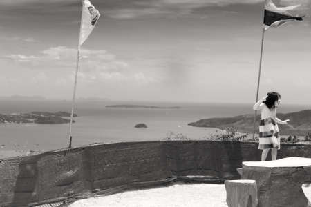 PHUKET, THAILAND FEBRUARY 15 2013: A young Korean girl mugs for a photo at the Big Buddha Monument, one of the most visited landmarks in Phuket and an iconic symbol of Buddhism in Thailand.のeditorial素材