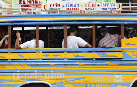 PHUKET TOWN, PHUKET, THAILAND AUGUST 12 2012: Passengers sitting in a public bus at a bus depot in Phuket Town wait for departure.のeditorial素材