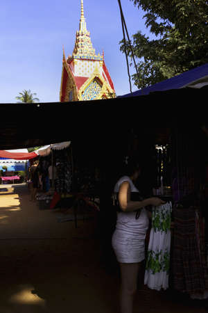 WAT KARON MARKET, KARON, PHUKET, THAILAND FEBRUARY 16 2013: A woman looks at some clothes for sale on Market Day at Temple Karon in Karon Beach.のeditorial素材