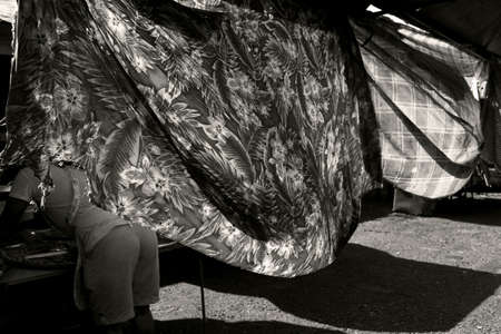 PHUKET TOWN, PHUKET, THAILAND APRIL 19 2013: A food vendor arranges Thai style snack and finger food on a tray at at the Downtown Market in Phuket Town.のeditorial素材