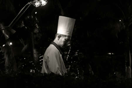 THAVEEWONG ROAD, PATONG, PHUKET, THAILAND FEBRUARY 13 2013: A Chef at a beach front hotel works an outdoor dinner buffet on Thaveewong Road in Patong Beach. のeditorial素材