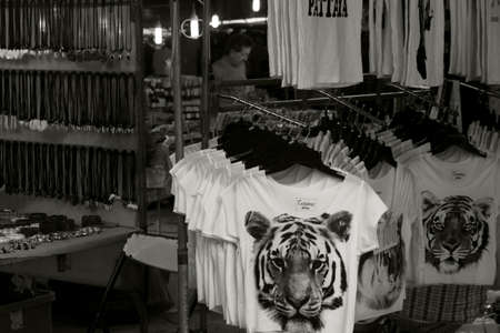 WAT KARON MARKET, KARON, PHUKET, THAILAND FEBRUARY 9 2013: A market stall under a tent in the courtyard of Temple Karon sells T-shirts and other souvenirs on Market Day.のeditorial素材