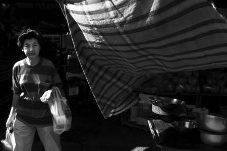 DOWNTOWN MARKET, PHUKET TOWN, PHUKET, THAILAND: APRIL 19 2013: A woman goes shopping in the late afternoon at Downtown Market in Old Town Phuket.のeditorial素材
