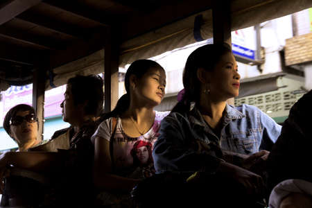 PHUKET TOWN, PHUKET, THAILAND SEPTEMBER 8 2012: Four passengers take a public bus bound for Patong Beach from Phuket Town.のeditorial素材