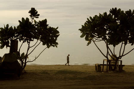 PATONG BEACH, PHUKET, THAILAND OCTOBER 24 2012: A tourist takes a stroll at dusk along Phuketのeditorial素材