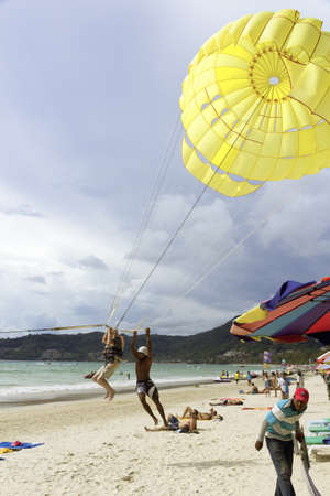 PATONG BEACH, PHUKET, THAILAND AUGUST 23 2011: A jet ski rental operator sets down with a rider on Patong Beach.のeditorial素材