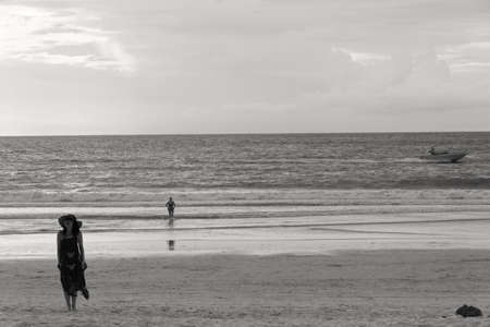 PATONG BEACH, PHUKET, THAILAND AUGUST 14 2011: A jet ski tow boat speeds past a couple of tourists at dusk.のeditorial素材
