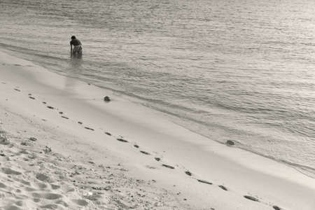 KALIM BEACH, PHUKET, THAILAND JANUARY 20 2013: A lone fisherman trolls for a catch in the late afternoon along Kalim Beach.のeditorial素材