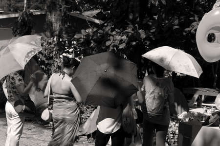 SURIN BEACH, PHUKET, THAILAND JANUARY 31 2013: A group of tourists take a break under the shade of their umbrellas at Surin Beach during high season in Phuket.のeditorial素材