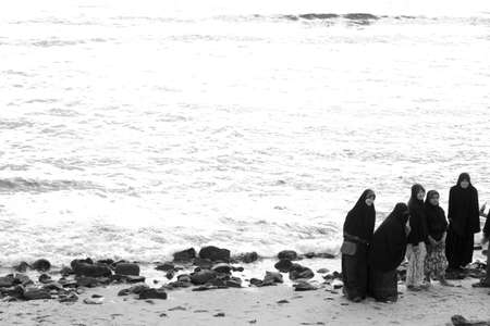 KALIM BEACH, PHUKET, THAILAND APRIL 15 2013: A group of Thai Muslim teenagers pose for a group photo at the beach.のeditorial素材