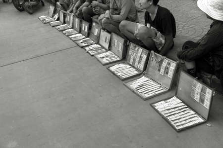 BANZAAN MARKET, PATONG, PHUKET, THAILAND APRIL 15 2013: Lottery ticket vendors congregate on the sidewalk of Banzaan Market. のeditorial素材