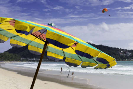 PATONG BEACH, PHUKET, THAILAND, AUGUST 3 2011: A parasail operator soars high above the sand with a customer during a ride on Patong Beach.のeditorial素材