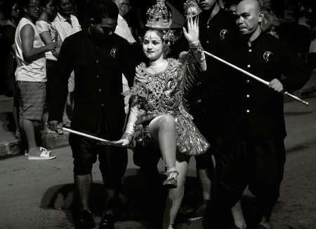STREET FESTIVAL, PATONG BEACH, PHUKET, THAILAND, 15 DECEMBER 2013: A mime dressed in traditional Thai clothing performs during a street festival/parade in Patong Beach.のeditorial素材