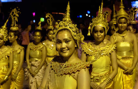 STREET FESTIVAL, PATONG BEACH, PHUKET, THAILAND, 15 DECEMBER 2013: Dancers in traditional Thai clothing march past down The Beach Road during a street festival/parade in Patong Beach.のeditorial素材
